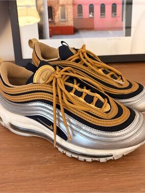 Nike sneakers in gold and black with white label